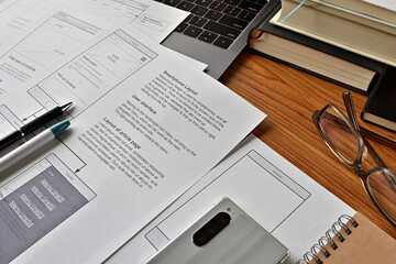 On the desk where I am doing web design. There is a wireframe printable and a pen.