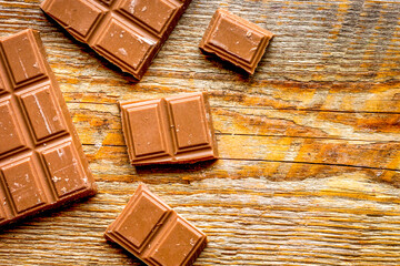chopped chocolate pieces for dessert wooden desk background top view space for text