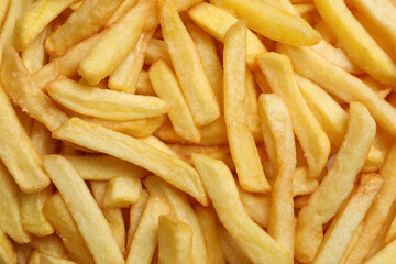 Yummy French fries as background, top view