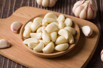 Garlic Cloves and Garlic Bulb on vintage wood background