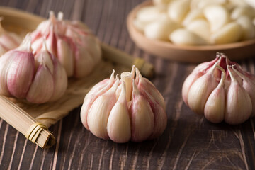 Garlic Cloves and Garlic Bulb on vintage wood background