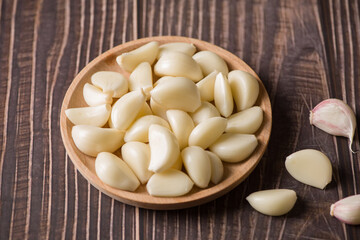 Garlic Cloves and Garlic Bulb on vintage wood background