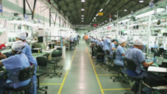 Blurred Workers in a Large Industrial Factory, Assembly Line, Fast Motion - 4K