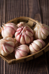 Garlic Cloves and Garlic Bulb on vintage wood background