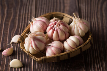 Garlic Cloves and Garlic Bulb on vintage wood background