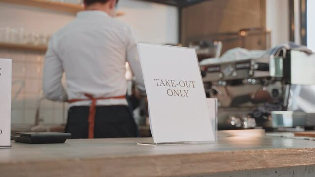 Asian cafe owner put Take Out Only announcement sign on counter bar.