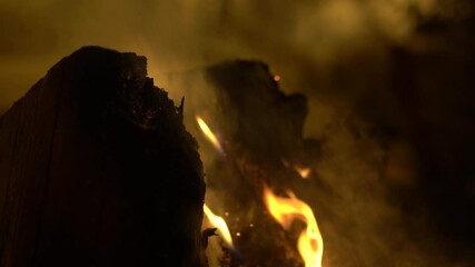 logs and other material burning in fire