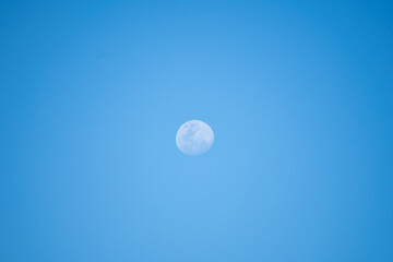 3 quarter moon in the daylight sky