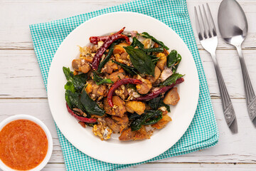 Flat lay crispy fried herb chicken with garlic and black pepper, a simple savory Thai food dish that is good to pair with either plain cooked rice or alcoholic drinks. 