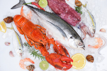 Fresh fish and seafood plate with Shellfish shrimps prawns crab shell squid octopus crab lobster and fish ocean gourmet dinner, Fresh raw seafood on ice with herbs and spices at the fish market food