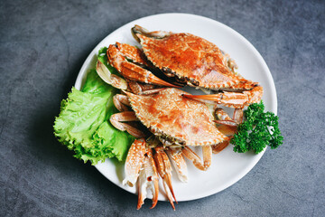 Fresh seafood crab cooking food in the restaurant, Steamed or boiled Blue Swimming Crab ocean gourmet with salad vegetables lettuce, top view