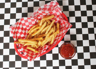French Fried Potatoes in Retro Cafe With Checkered Paper