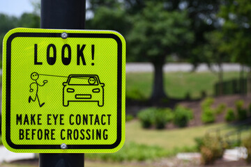 Bright yellow pedestrian crossing make eye contact before crossing look