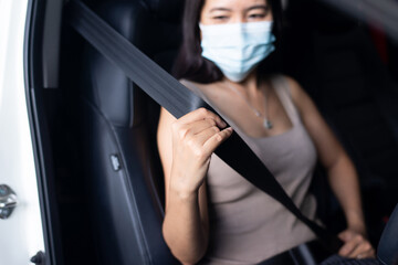 Woman driver fastens seat belt before driving a car,Safety concept for vehicles
