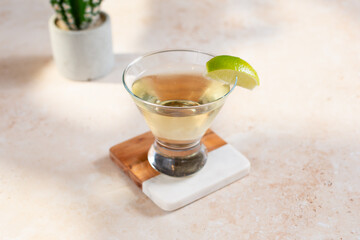 A view of a simple tequila beverage, garnished with a lime wedge.