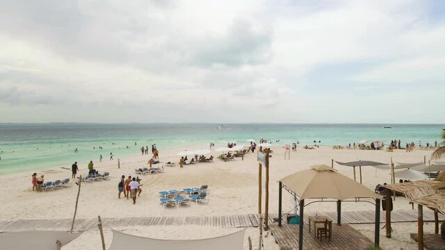 Tropical Seascape With People Enjoying The Beautiful Beach And Sand Of Playa Indios in Isla Mujeres, Mexico - wide shot
