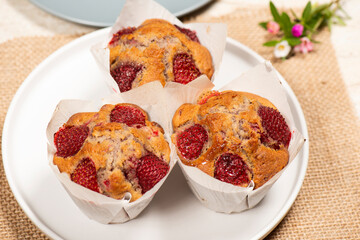Homemade baked muffins with delicious fresh strawberries