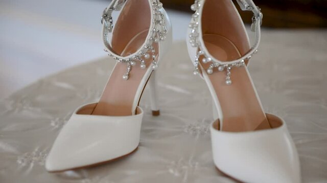 Close-up circling view of luxurious bridal shoes on wedding day