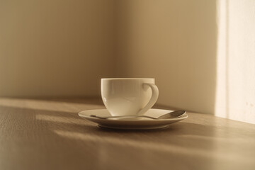 White coffee mug on the wooden table warm light