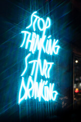 sign in the night LED neon light wording Stop thinking start drinking