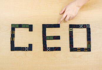 hand holding a domino wording CEO