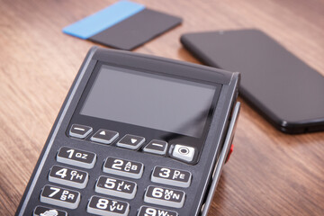 Payment terminal with credit card and mobile phone. Cashless paying for shopping. Finance concept