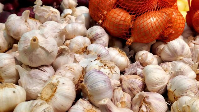 Stack of garlic and onion in grocery store. Industry of selling products