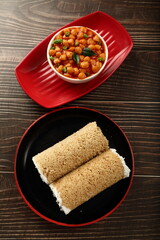 Homemade breakfast- steamed whole wheat puttu with chickpeas curry- Asian vegetarian diet foods.