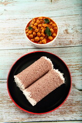 Healthy vegan diet food- steamed red rice puttu with chickpea curry. Tamilnadu, Kerala foods.