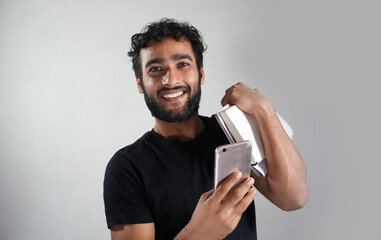 a man with white background having books and mobile