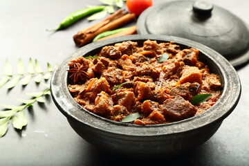 Traditional cooking- Indian mutton curry cooked in clay pot .earthen ware, pottery   - obrazy, fototapety, plakaty