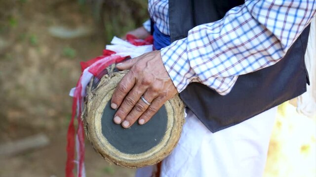a man playing a cultural instrument that called madal in slow motion
