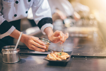 Hand of man take cooking of meat with vegetable grill, Chef cooking wagyu beef in Japanese teppanyaki restaurant