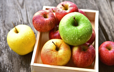 colorful of 3 Type of apple,Gala,Granny Smith,Golden Delicious in wooden box and wooden background.