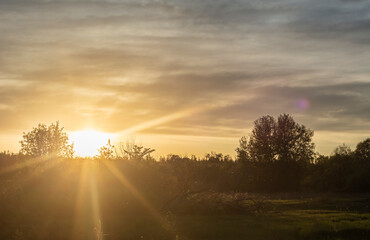 sun rises sets over green field 