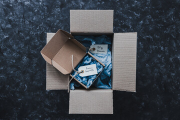 product tags with small business vs big brand texts inside of bigger and smaller delivery parcels,...