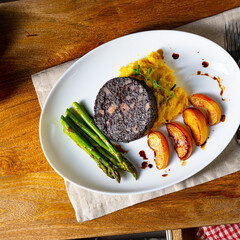 Black pudding with green asparagus and fried apple