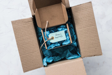 product tag with small business text inside ofsmaller delivery parcel inside of a bigger parcel, supporting small local businesses
