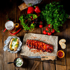 spicy spare ribs with baked potatoes and sour cream - obrazy, fototapety, plakaty