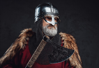 Studio shot of old age templar holding axe