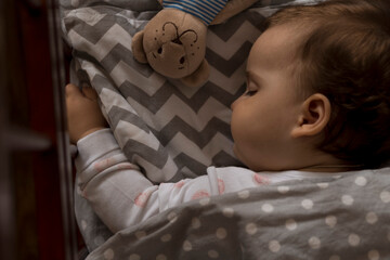 top view Cute little chubby baby girl kid sleeping sweetly in grey crib during lunch rest time in...
