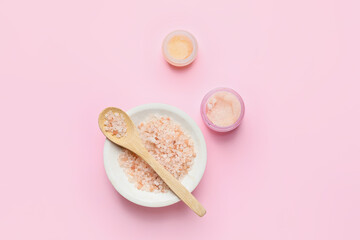 Jars of body scrub and sea salt on color background