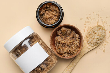 Jars of body scrub and sea salt on color background, closeup