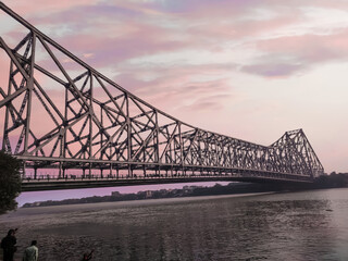 Howrah bridge - The historic cantilever bridge on the river Hooghly with twilight sky.