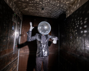 Mr disco ball dancing in a lift