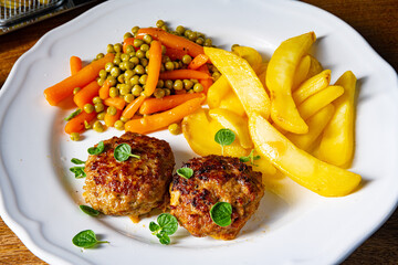 Homemade meatballs with french fries and vegetables