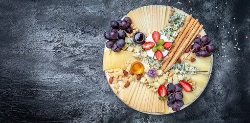 Antipasto Cheese board of various types of soft and hard cheese. spanish manchego cheese, International dairy delicacies. Dinner or aperitivo party concept. catering banner, menu, recipe