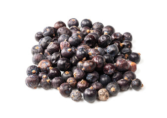 pie of dried juniper berries closeup on white