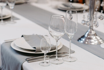Table service in the restaurant. Transparent clean glasses and wine glasses. Christmas table decoration.