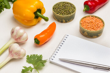 Pen and notebook. Bulgur and chickpeas in bowls.
